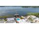 Aerial view of the property showcasing the pool, boat house, dock, and stunning lakefront location at 2202 Starboard, Winter Haven, FL 33881