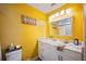 Bathroom with bright yellow walls and double sinks at 2202 Starboard, Winter Haven, FL 33881
