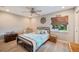 Cozy bedroom with seaside inspired decor, wood floors, and ceiling fan at 2202 Starboard, Winter Haven, FL 33881
