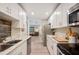 Bright kitchen features white cabinets, stainless steel appliances, and marble countertops at 2202 Starboard, Winter Haven, FL 33881