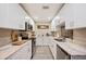 Bright kitchen featuring stainless steel appliances, granite countertops, and white cabinetry at 2202 Starboard, Winter Haven, FL 33881
