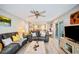 Spacious living room with hardwood floors, ceiling fan, and sliding glass doors at 2202 Starboard, Winter Haven, FL 33881