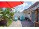 Outdoor patio seating area with tropical plants and decor at 2202 Starboard, Winter Haven, FL 33881