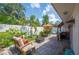 Outdoor patio area with firepit, tropical landscaping, bar, and seating at 2202 Starboard, Winter Haven, FL 33881