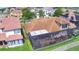 Aerial view of the home, showing the tiled roof, screened lanai, and patio furniture at 2340 Pinehurst Ct, Davenport, FL 33837