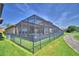 Spacious backyard with enclosed patio, landscaping, and a view of the greenway at 2340 Pinehurst Ct, Davenport, FL 33837