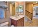 Bathroom featuring vanity with cabinetry, an illuminated mirror, and access to the staircase at 2340 Pinehurst Ct, Davenport, FL 33837