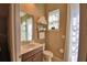 Bathroom with a vanity, towels, a window, and a mirror at 2340 Pinehurst Ct, Davenport, FL 33837