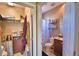 A view into a half bathroom and walk-in closet with shelving for storage at 2340 Pinehurst Ct, Davenport, FL 33837