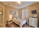 Bedroom featuring natural light, stylish decor, and neutral color palette at 2340 Pinehurst Ct, Davenport, FL 33837