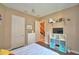 Cozy bedroom featuring a white dresser and cube storage unit with colored storage bins at 2340 Pinehurst Ct, Davenport, FL 33837