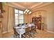 Formal dining room with seating for eight, elegant lighting, and a bright window at 2340 Pinehurst Ct, Davenport, FL 33837