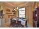Elegant dining room featuring a table set for eight, a chandelier, and a large window at 2340 Pinehurst Ct, Davenport, FL 33837