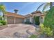 Lovely home exterior with a two car garage, brick paved driveway, and manicured green bushes at 2340 Pinehurst Ct, Davenport, FL 33837