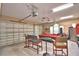 Spacious garage featuring a pool table, high ceilings, ample lighting, and two garage doors at 2340 Pinehurst Ct, Davenport, FL 33837