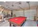Spacious garage with a pool table and plenty of room for storage, plus two garage doors at 2340 Pinehurst Ct, Davenport, FL 33837
