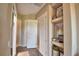 Bright hallway featuring hardwood floors, built-in shelves, and access to multiple rooms, creating an inviting atmosphere at 2340 Pinehurst Ct, Davenport, FL 33837