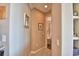Hallway with beige walls and view into a bathroom at 2340 Pinehurst Ct, Davenport, FL 33837