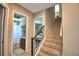 Hallway showcasing a staircase and an open bathroom with tile floors and modern fixtures at 2340 Pinehurst Ct, Davenport, FL 33837