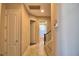 Hallway leading to bathroom with tiled flooring, access to the staircase, and neutral-colored walls at 2340 Pinehurst Ct, Davenport, FL 33837