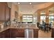 Open-concept kitchen with granite counters and stainless steel appliances, flowing into the dining and living area at 2340 Pinehurst Ct, Davenport, FL 33837