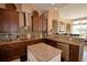 A spacious kitchen with granite countertops, a central island, and stainless steel appliances, perfect for cooking at 2340 Pinehurst Ct, Davenport, FL 33837