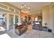 Open living area with sliding doors and a view of the outdoor living space and a modern kitchen at 2340 Pinehurst Ct, Davenport, FL 33837