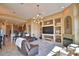 This living room is open and features a fireplace, built-in shelves, and a view of the kitchen area at 2340 Pinehurst Ct, Davenport, FL 33837