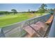 View of outdoor screened patio with dining areas and views of the golf course at 2340 Pinehurst Ct, Davenport, FL 33837