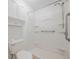 Accessible bathroom features grab bars, handheld shower, and convenient shelving at 2409 E Civitan Ave, Lakeland, FL 33801
