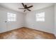 Bright bedroom featuring wood-look flooring, neutral color scheme, and natural light at 2409 E Civitan Ave, Lakeland, FL 33801