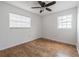 This bedroom features light colored cork floors, ceiling fan, and natural lighting at 2409 E Civitan Ave, Lakeland, FL 33801