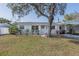 Charming single-story home with a well-maintained lawn and covered parking at 2409 E Civitan Ave, Lakeland, FL 33801
