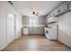 Bright kitchen featuring updated appliances, light-colored cabinets and hardwood flooring at 2409 E Civitan Ave, Lakeland, FL 33801