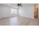 Spacious living room with hardwood flooring, ceiling fan, and ample natural light at 2409 E Civitan Ave, Lakeland, FL 33801