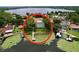 Lakeside home featuring a private dock and screened pool, nestled among vibrant lily pads at 255 Lake Link Rd, Winter Haven, FL 33884