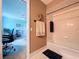Neutral bathroom with bath tub, towel rack, coastal-themed decor and view to blue living room at 255 Lake Link Rd, Winter Haven, FL 33884