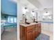 Bathroom features double sinks with unique copper basin bowls and view to the primary bedroom at 255 Lake Link Rd, Winter Haven, FL 33884