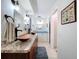 Bathroom showcases double vanity with copper sinks and modern fixtures, accented with beachy décor at 255 Lake Link Rd, Winter Haven, FL 33884