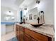 Bathroom features double sinks and a vanity area with ample storage, adjacent to the walk-in closet at 255 Lake Link Rd, Winter Haven, FL 33884