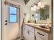 Bathroom featuring vanity with sink and drawers, complemented by an adjacent door to the exterior at 255 Lake Link Rd, Winter Haven, FL 33884