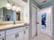 Bathroom with white vanity, integrated sink and cabinetry, providing storage and counter space at 255 Lake Link Rd, Winter Haven, FL 33884