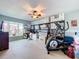 Bedroom with exercise equipment, large window, shelves and closet at 255 Lake Link Rd, Winter Haven, FL 33884