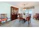 Bright dining room with wooden furniture, a china cabinet, and a view to the pool at 255 Lake Link Rd, Winter Haven, FL 33884
