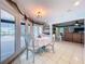 Bright dining area featuring tiled floors, direct access to the pool via sliding glass doors and neutral decor at 255 Lake Link Rd, Winter Haven, FL 33884