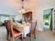 Dining room features classic wooden furniture, an elegant chandelier, and access to the bedroom at 255 Lake Link Rd, Winter Haven, FL 33884