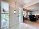 Inviting entryway featuring white tile flooring, a white front door and sidelight windows for natural light at 255 Lake Link Rd, Winter Haven, FL 33884