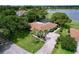 Charming single-story home with a well-manicured lawn, mature trees, and a screened-in pool area at 255 Lake Link Rd, Winter Haven, FL 33884