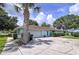 Charming single-story home with a well-manicured lawn, palm trees, and an inviting driveway at 255 Lake Link Rd, Winter Haven, FL 33884
