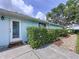 A vibrant wall featuring meticulously manicured shrubbery and a welcoming doorway at 255 Lake Link Rd, Winter Haven, FL 33884